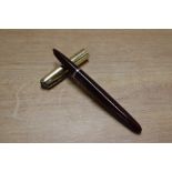 A Parker 51 vacumatic fill fountain pen in Cordovan Brown with Gold fill converging line cap.