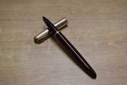 A Parker 51 vacumatic fill fountain pen in Cordovan Brown with Gold fill converging line cap.