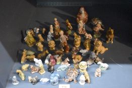 A large assortment of English Pottery Wade 'Whimsies' to include squirrel, tortoise, cow, horse,