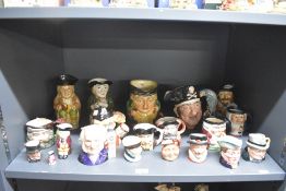 An assortment of twenty Royal Doulton bone china and Beswick Pottery Toby character jugs including