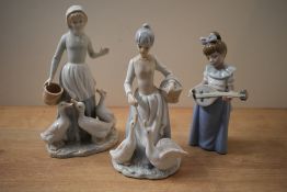 A Nao by Lladro porcelain figurine 'Girl with Mandolin' model number 1033, sold alongside two