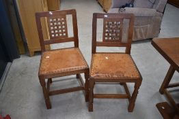 Workshop of Robert Mouseman Thompson of Kilburn; A golden oak dining table and set of six lattice