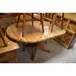 A modern pine rounded rectangular pedestal dining table with demi-lune leaves, 72cm x 151cm x 91cm