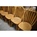 A set of four traditional lightwood kitchen chairs having hoop and rail backs, and a similar