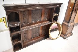 A period oak dresser back having carved decoration to panels, some damage to shelves. Width