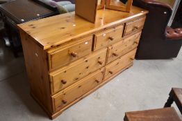 A modern yellow pine bedroom chest of three short over four long side by side drawers , width