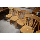 A set of four traditional beech fiddle back kitchen chairs