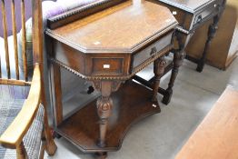 An early 20th Century oak hall table, labelled James Bowie of Ayr, having canted front with frieze