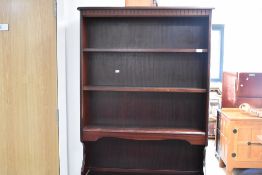A late 20th Century mahogany effect lounge unit comprising shelves over faux leaded glass lower