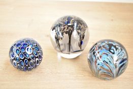 Two 20th-century Adrian Sankey studio glass paperweights, to include a swirling flower example; sold