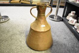 A large late 19th to early 20th-century copper ewer, of broad body with twin sculpted handles,
