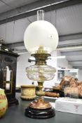 An early 19th-century Palmer and Co Patent oil lamp, featuring a frosted globe shade, Palmer and