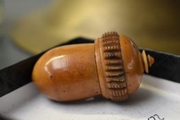 A small mid to late 19th century treen acorn-shaped needle case, featuring a screw top that