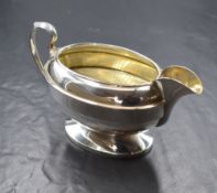 A George VI silver sauce boat, of oval form having a moulded rim, narrow spout opposed by a c-