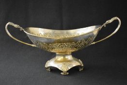 An impressive 20th century silver plated basket, of oval form having a moulded rim, floral scroll