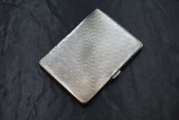 A George V silver cigarette case, of hinged rectangular form having engine turned decoration,