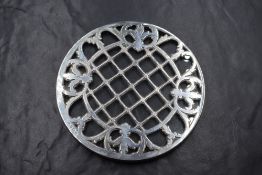 A George V silver mounted glass coaster, having diaper and scroll decoration, marks for Birmingham