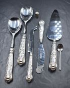 A boxed pair of Elizabeth II silver handled Queen's pattern salad servers, with a matching cake