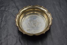 A late George V silver Harrods dish, having a flared Chippendale style rim, marks for Birmingham