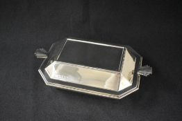 A George V silver Art Deco serving dish, of rectangular form having decorative angular fan handles