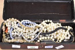 A small assortment of costume jewellery, including faux pearls, statement pieces and brooches, in