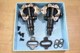 A pair of Shimano bicycle pedals in new used condition.