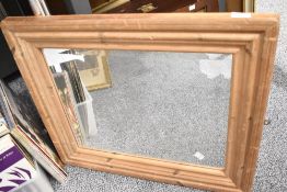 A contemporary oak framed wall mirror, 56cm x 66cm, condition is consistent with age and use,
