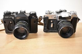 Two Zenit E cameras, one silver and black, the other black, both with Helios 58mm f2 44-2 lenses,