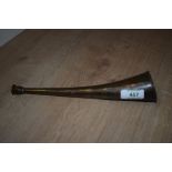 A small brass hunting horn of slight curved form measuring 25cm long bearing a few ssmall dents