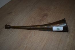 A small brass hunting horn of slight curved form measuring 25cm long bearing a few ssmall dents