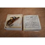 A vintage hardy cardboard box containing a Salmon fly brooch or badge for fishing hat