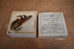 A vintage hardy cardboard box containing a Salmon fly brooch or badge for fishing hat