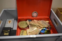 An assortment of fishing tackle including an unused fly tin by Wheatly and an unused fly tying vice