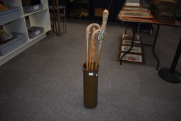 A Large copper shell case made into a stick stand measuring 51cm high and containing 4 assorted