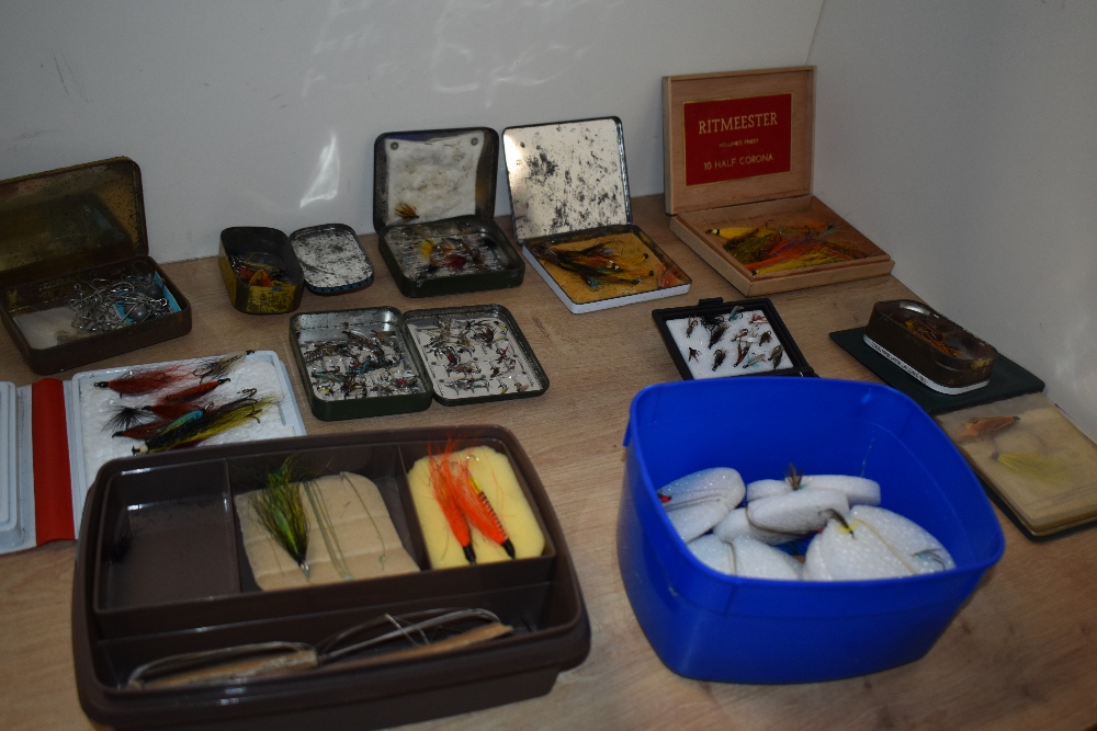 A selection of fishing flies both salmon and trout in various tins and boxes