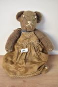 A late 19th-century hand made teddy bear, of a light brown fur, a stitched nose, mouth, paws and