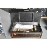 A late 19th to early 20th-century cylinder music box, rosewood with inlaid decorative elements and