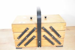 A vintage Polish wooden cantilever sewing box, featuring five multi-tiered, unfolding storage