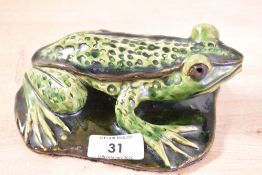 A small early 20th-century green ceramic frog figurine, featuring a sweet mossy crackle-glaze