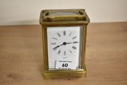 A small 20th-century French 'Jackson Paris' brass and glass carriage clock, featuring a white enamel