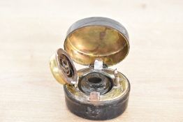 A 19th-century Austrian leather-covered brass travelling inkwell, having 'ink' in gilded scripture