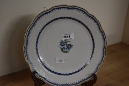 A Victorian Royal Doulton-style ceramic plate, featuring a blue floral pattern, with a scalloped r