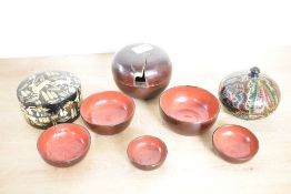 A nested set of mid 20th-century Japanese wooden lacquerware bowls/saki cups with colourful red