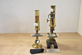 Two late 19th to early 20th-century brass scientific microscopes, to include a taller monocular