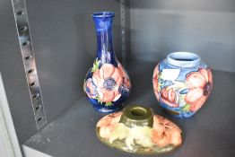 A collection of 20th century Moorcroft pottery, compromising of an Anenome design long neck bud vase