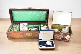 A Eastern wooden jewellery box, having decorative metal corner covers and carved green stone