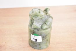 A 20th-century Chinese carved green-stone seal 'chop' stamp, featuring an intricately carved foo-dog