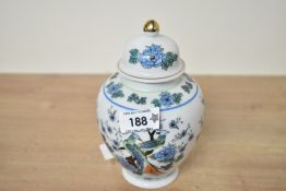 A late 20th-century Chinese porcelain ginger jar, featuring a gilt finial, lidded rim, and decorated