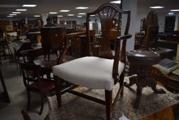 A group of six George III mahogany type dining chairs five single and one carver, with yoke-form top