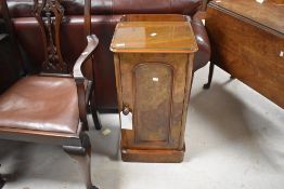 A 19th century figured walnut bedside cupboard, of traditional design with moulded and rounded
